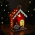 Karácsonyi LED-es dekoráció - házikó manóval - melegfehér LED, piros - 7,5 x 5 x 10 cm - 2 féle       BX59746